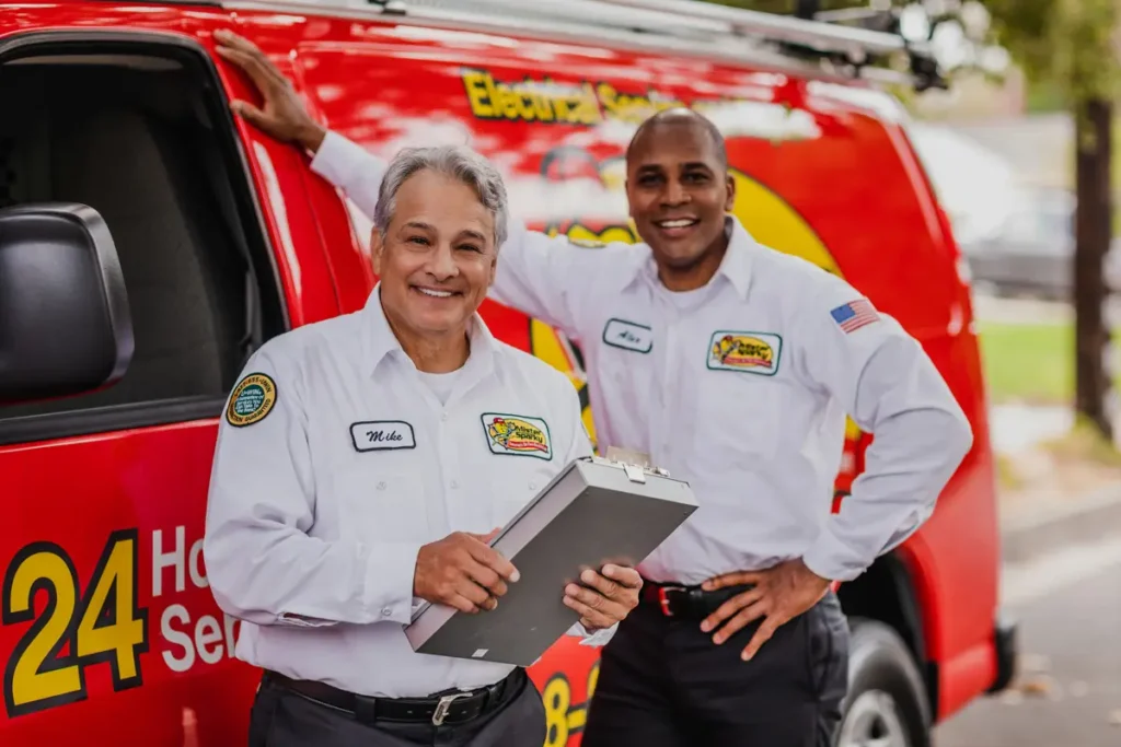 Two electricians in front of a Mister Sparky van How Do Natural Gas vs. Propane Generators Compare?